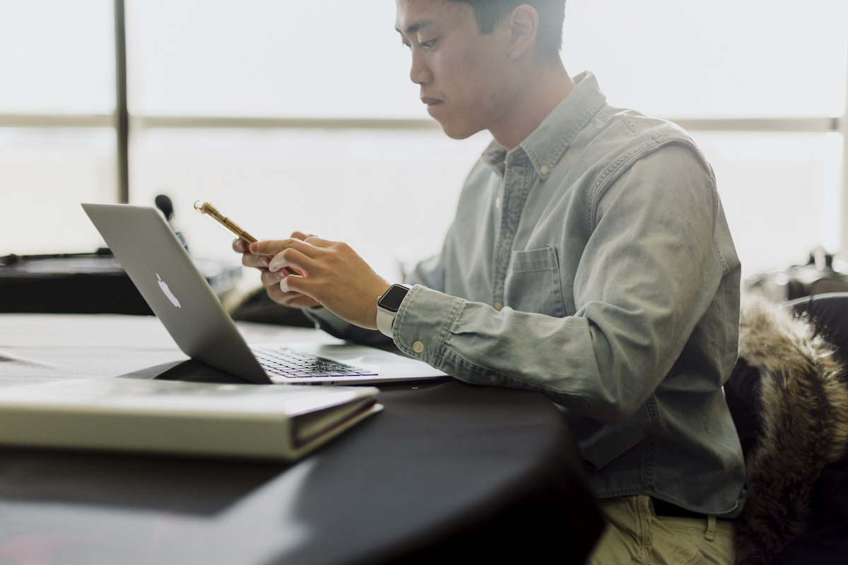 Business owner planning succession at his laptop