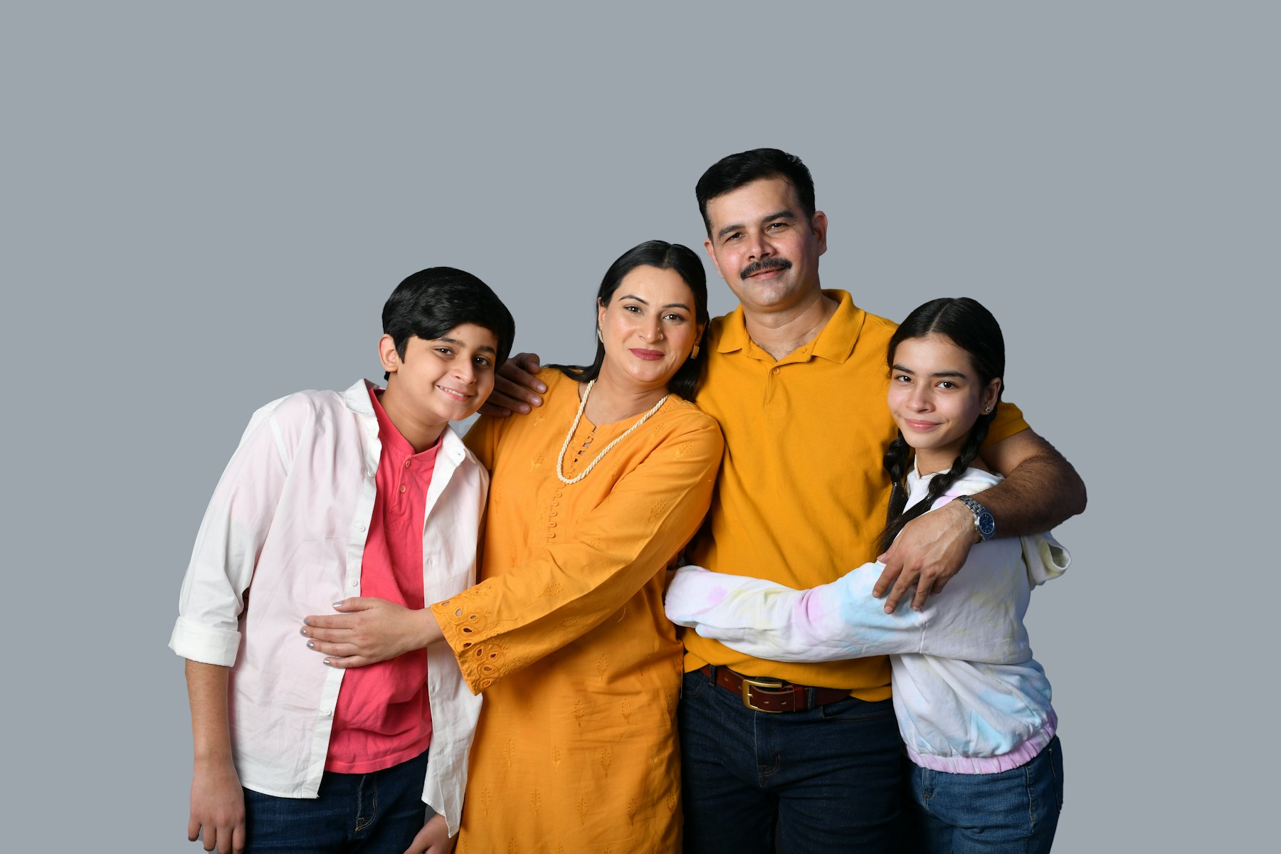 Smiling family of four standing together