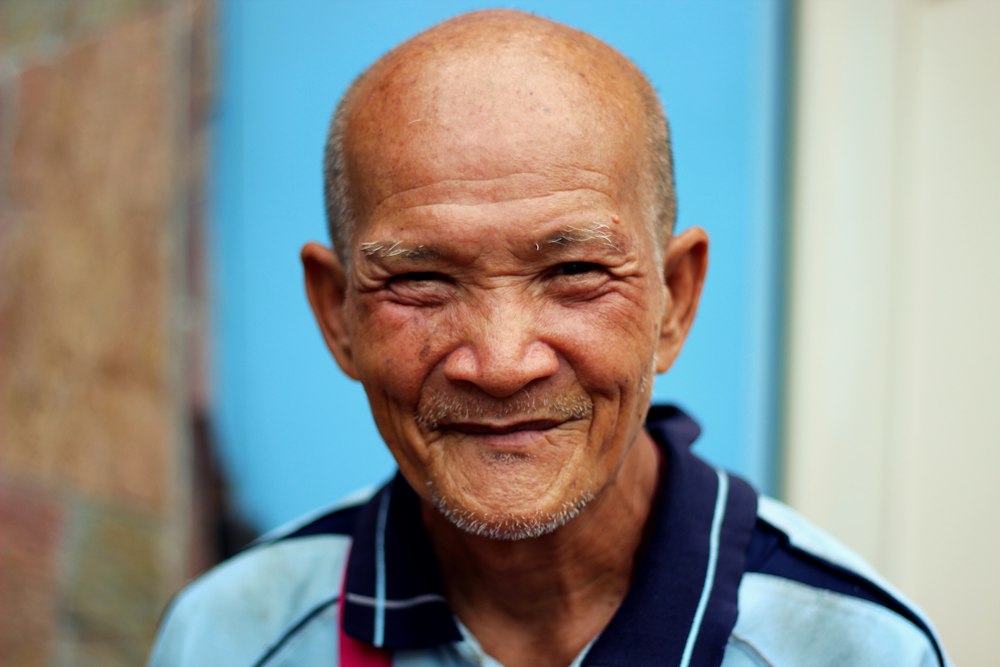 Smiling elderly Malaysian man