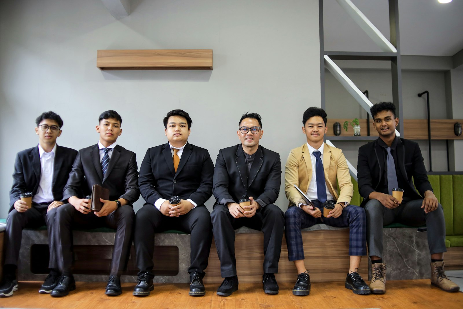 Business team in suits seated together for a group photo