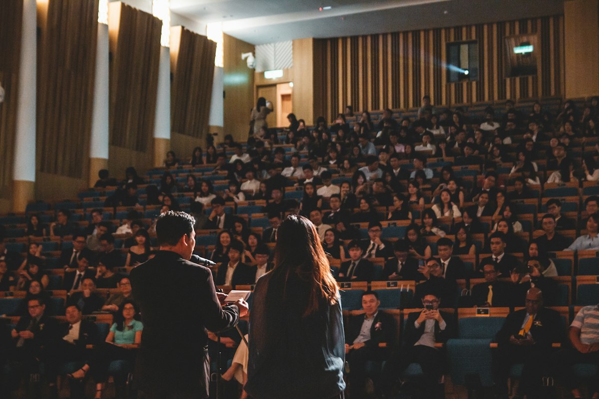 Speaker presenting to a full lecture hall