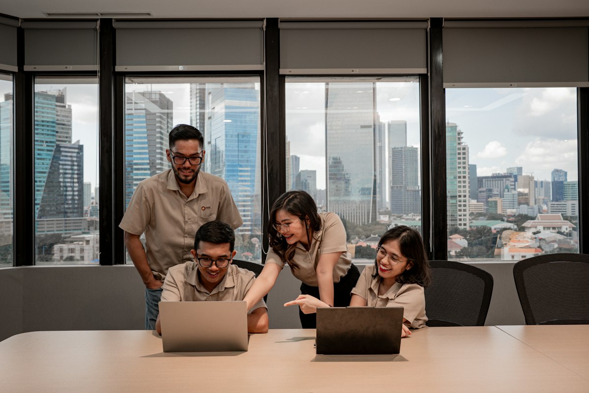 Team meeting around laptops in a city office