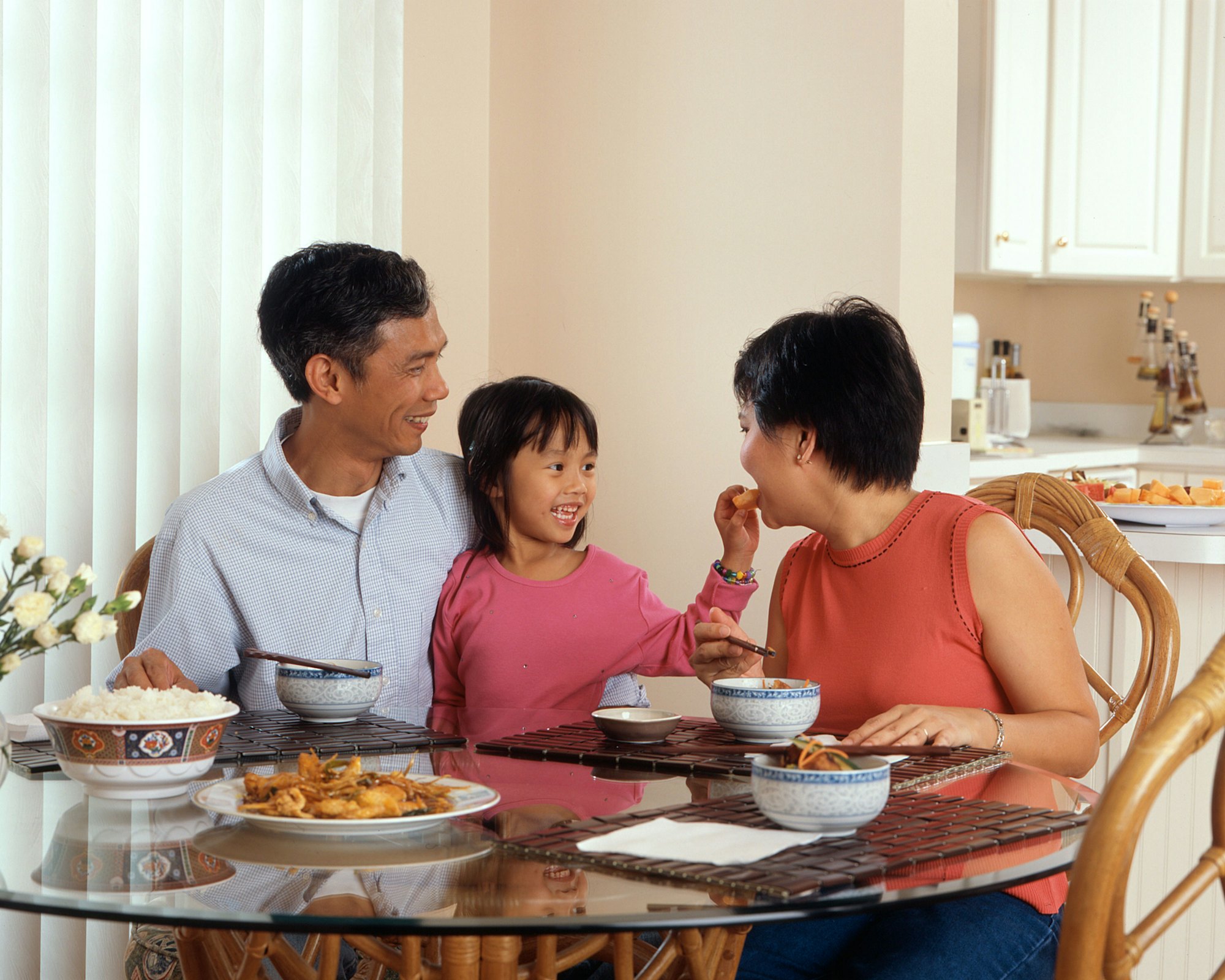 Malaysian family sharing a home-cooked meal at the dining table