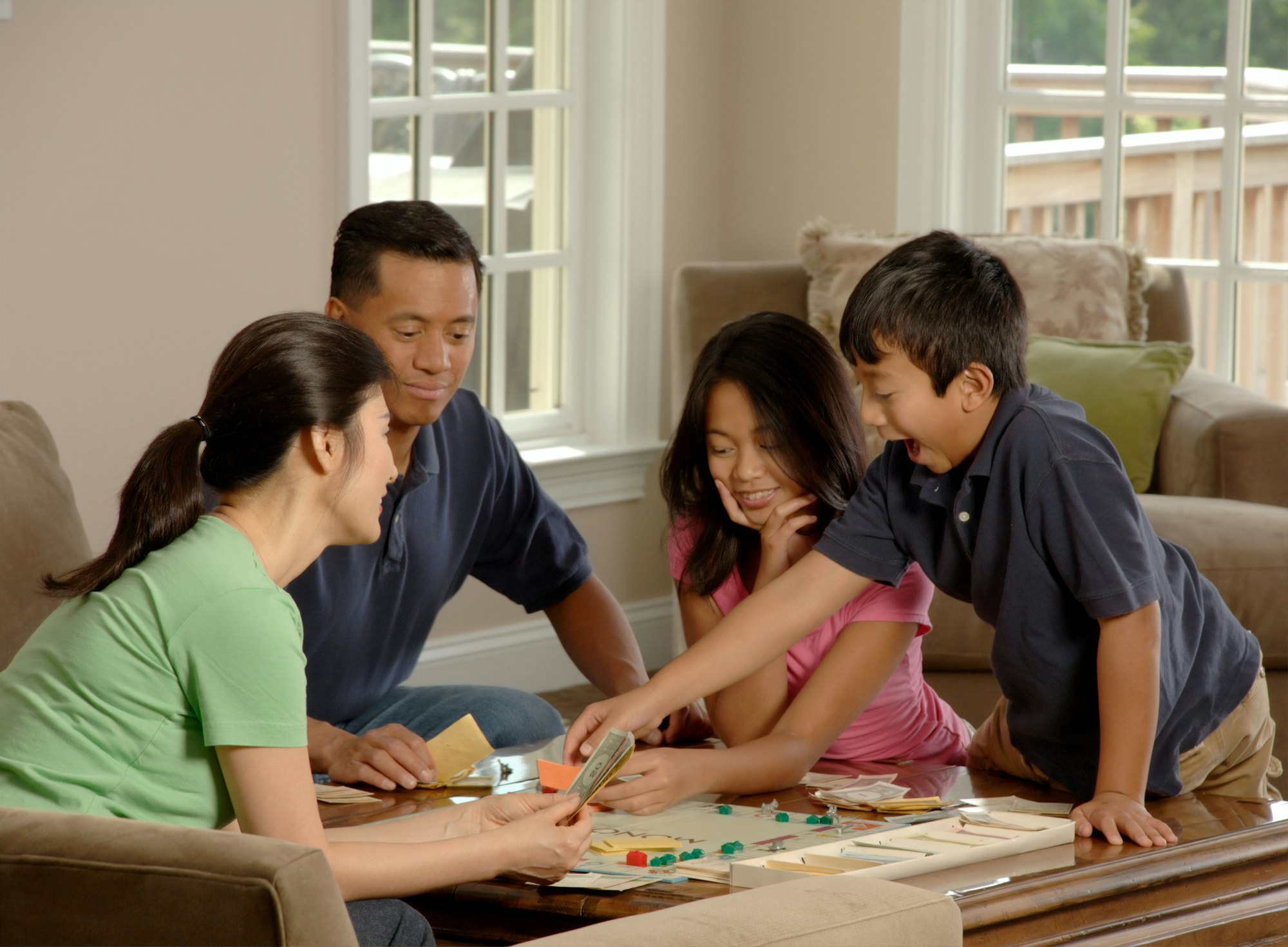 Family playing a board game together in the living room