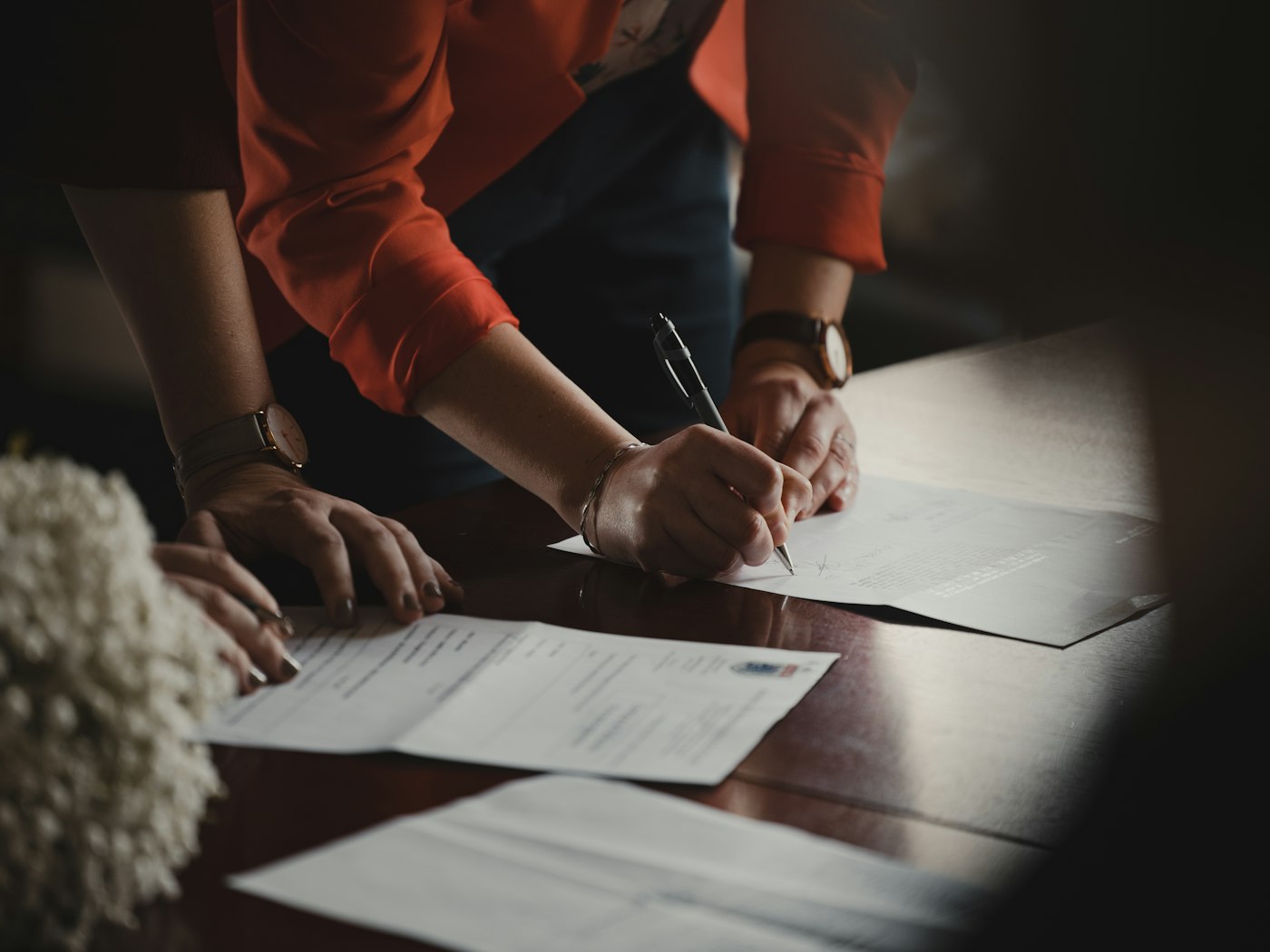 Family signing estate administration papers at a table